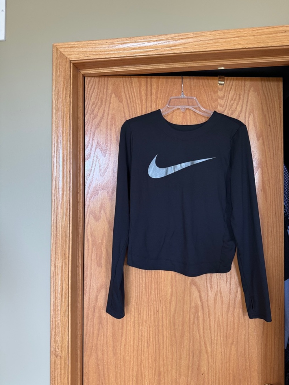 Nike Black Long-Sleeve Cropped Athletic Top with Silver Swoosh